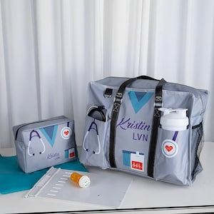 May include: A gray and blue medical themed tote bag with a stethoscope, heart, and EKG graphic. The bag has a black zipper and black straps. The bag is personalized with the name "Kristin LVN".