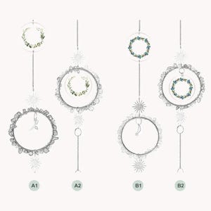May include: Four hanging suncatchers with clear circular frames and decorative elements. Two feature wreaths of green leaves, while the other two have blue and green floral wreaths. Each is suspended by a chain with star and moon accents.