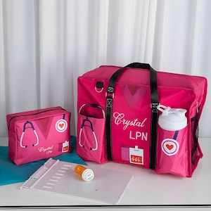 May include: Pink travel bag with a stethoscope and heart graphic, a smaller pink zippered pouch with the same graphic, a white water bottle, and a clipboard. The bag has the name "Crystal LPN" printed on it.