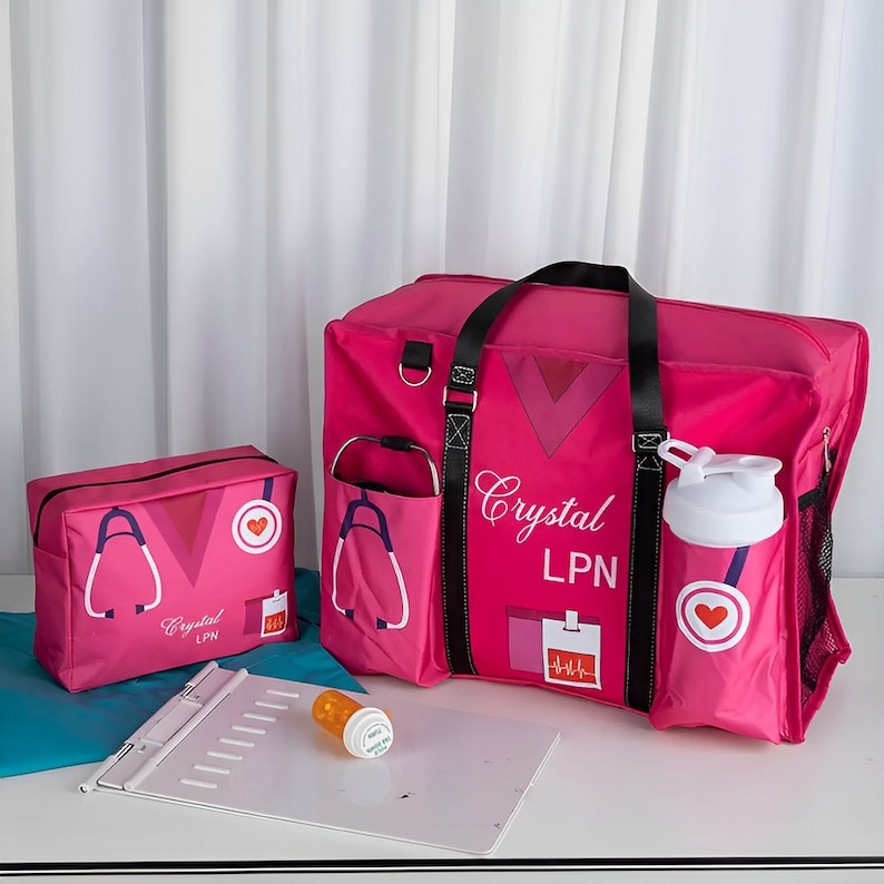 May include: Pink travel bag with a stethoscope and heart graphic, a smaller pink zippered pouch with the same graphic, a white water bottle, and a clipboard. The bag has the name "Crystal LPN" printed on it.
