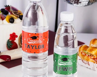 Puede incluir: Dos botellas de agua de plástico transparente con etiquetas con temática de graduación. Las etiquetas son naranja y verde con texto negro y un gráfico de gorro de graduación negro. La etiqueta naranja dice "Congrats TAYLOR" y la etiqueta verde dice "Congrats LEWIS".