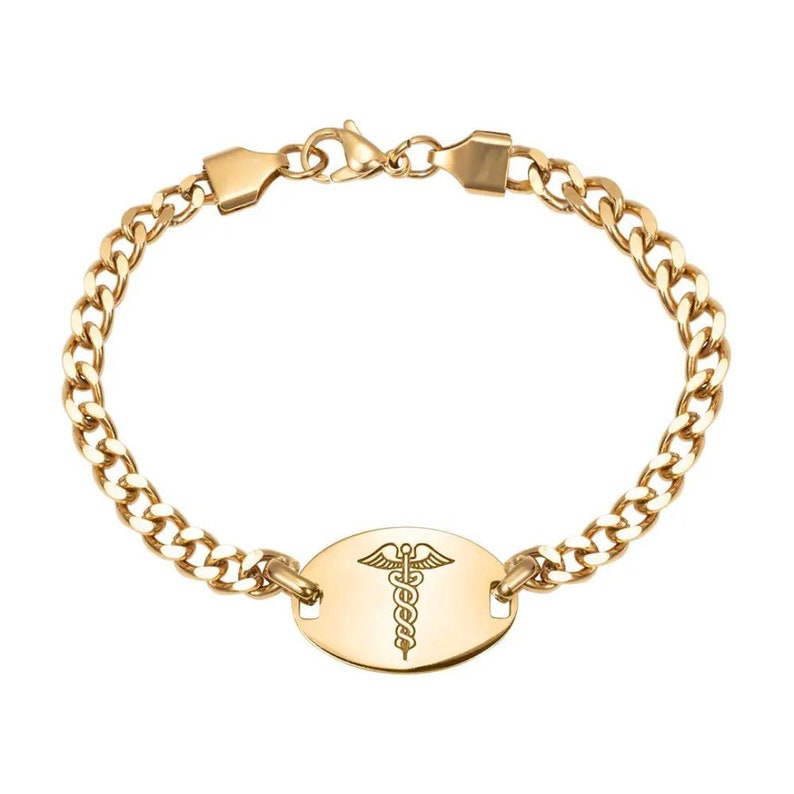 May include: Gold medical alert bracelet with a curb chain and an oval tag engraved with a caduceus symbol.