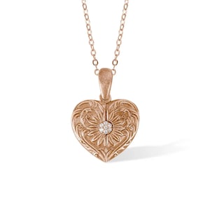 May include: A rose gold heart-shaped locket necklace with an intricate floral design and a small diamond accent.