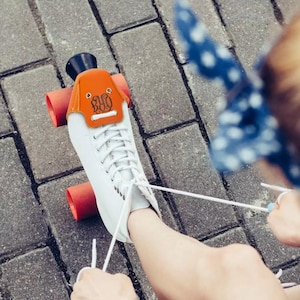 A pair of roller skate toe caps with customized text on them. Made of artificial leather, comes in 10 different colors. Protect the skates from scratches and add a personal touch. A great gift for skaters who love roller skating accessories.