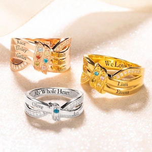 May include: Three gold, silver, and rose gold rings with engraved names and small gemstones. The rings are designed with a knot or bow shape and feature a row of small clear stones.