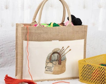 May include: A brown jute tote bag with a white canvas pocket featuring a basket of yarn and knitting needles. The pocket has the text "Grandma's Knitting Bits & Pieces".