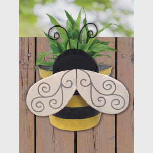 May include: A handmade wooden sign with the text "Welcome to our home" in a handwritten style. The sign is painted white with a distressed finish and features a decorative floral design. It is designed to be hung on a wall.