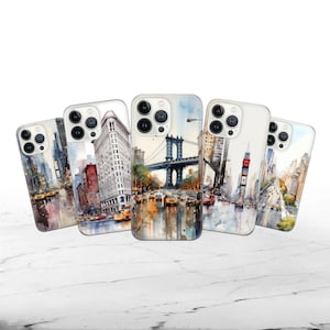 May include: Five different iPhone cases featuring watercolour illustrations of New York City landmarks. The cases depict the Brooklyn Bridge, the Flatiron Building, Times Square, and a general cityscape.