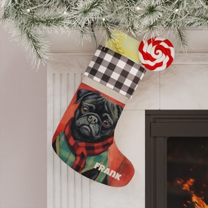 May include: A black and white checkered stocking with a red and white candy cane on top. The stocking has a picture of a black pug wearing a red and green scarf and the name "FRANK" written on it.