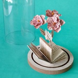 Miniature paper flowers and book in a dome