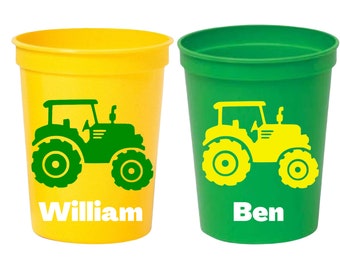 May include: Two yellow and green plastic cups with a tractor design and personalized names. The yellow cup says "William" and the green cup says "Ben".