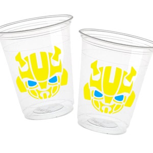 May include: Two clear plastic cups with yellow and blue Bumblebee Transformer character designs.