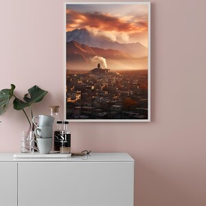 May include: A framed photograph of a city nestled in a valley with mountains in the background. The sky is a vibrant orange and pink with clouds. The city is lit by the setting sun.