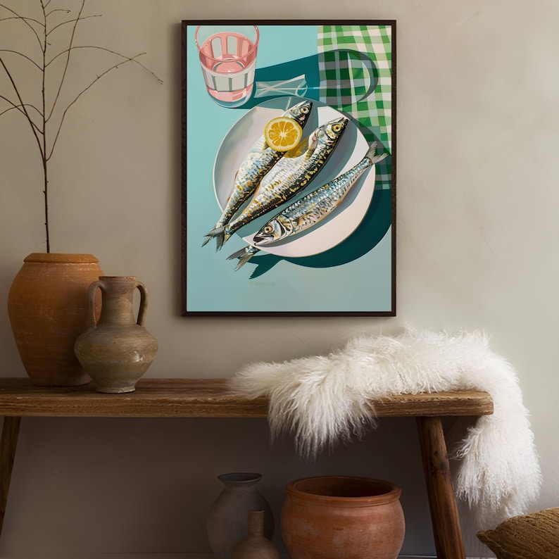 May include: A framed print of a still life featuring three whole sardines on a white plate with a lemon wedge. The plate is on a blue background with a green and white checkered tablecloth in the background.