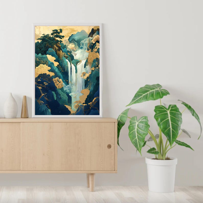 May include: A framed print of a waterfall cascading down a mountainside with lush green foliage and gold accents. The print is displayed on a wooden shelf with a potted plant.