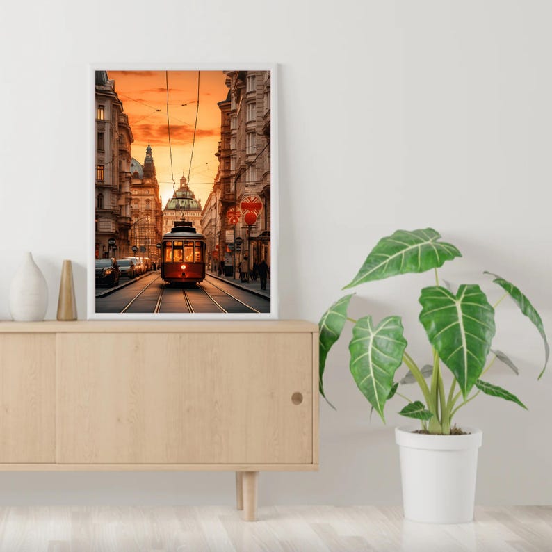 May include: A vintage red and white streetcar travels down a city street lined with buildings. The streetcar is illuminated by the setting sun, casting a warm glow on the scene.