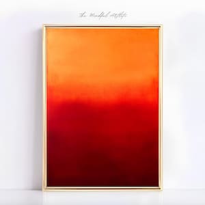 Könnte beinhalten: Abstraktes Gemälde in einem goldenen Rahmen mit einem Farbverlauf von Orange, Rot und Dunkelrot.