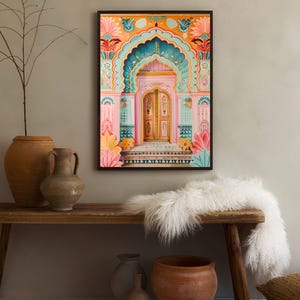 May include: A framed print of a colorful, ornate doorway with a pink archway and a teal and gold door. The doorway is decorated with intricate floral patterns and geometric designs.