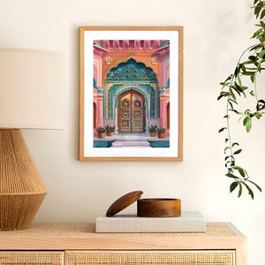 Peut inclure: Une impression encadr&eacute;e d'une porte color&eacute;e aux d&eacute;tails complexes. La porte est orn&eacute;e d'une arche turquoise et dor&eacute;e, et la porte elle-m&ecirc;me est d'un brun riche avec des sculptures orn&eacute;es. L'arri&egrave;re-plan est d'un rose et d'une p&ecirc;che doux.