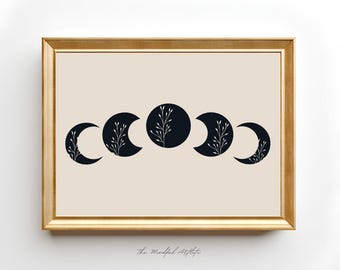 May include: A black and white print of five crescent moons with stylized branches inside each moon. The print is framed in a gold frame and has the text "The Mindful Artist" at the bottom.