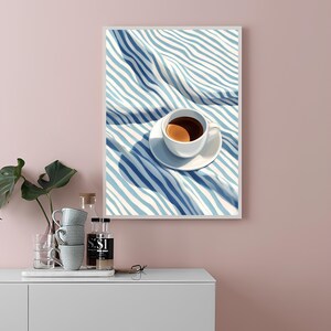 May include: A white coffee cup with a saucer filled with coffee sits on a blue and white striped fabric. The fabric is folded and has a shadow cast on it.