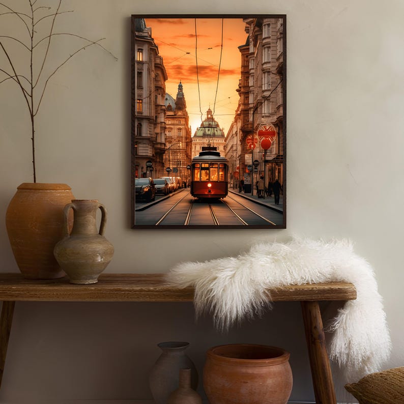 May include: A vintage red streetcar travels down a city street lined with buildings at sunset. The streetcar is illuminated by the setting sun, casting a warm glow on the scene.
