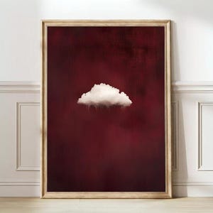 Könnte beinhalten: Ein gerahmter Druck eines weißen Wolken gegen einen dunkelroten Hintergrund. Die Wolke scheint zu regnen.