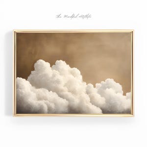 May include: A framed painting of a white cloud formation against a brown background. The clouds are fluffy and appear to be floating in the sky.