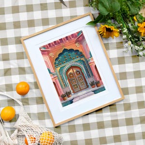 Peut inclure: Une impression encadr&eacute;e d'une porte orn&eacute;e et color&eacute;e avec un motif turquoise et or. La porte est sur un fond rose et orange.