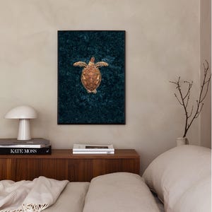 May include: A framed print of a sea turtle on a dark blue background. The turtle is facing upwards with its shell visible.
