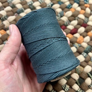 May include: A spool of dark teal cotton twine, perfect for crafting projects.