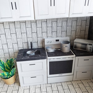 A digital printable template for a 1:12 scale dollhouse mini kitchen sink, designed for BMM system dollhouse setups. The template features a detailed, modern kitchen sink with a sleek faucet, ready to be printed on regular paper, cut, and assembled for a miniature kitchen scene.