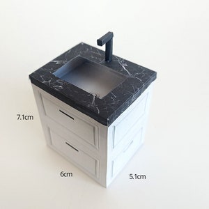 A digital printable template for a 1:12 scale dollhouse mini kitchen sink, designed for BMM system dollhouse setups. The template features a detailed, modern kitchen sink with a sleek faucet, ready to be printed on regular paper, cut, and assembled for a miniature kitchen scene.