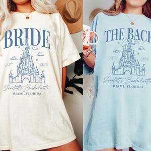 two women wearing t-shirts with the same design, which appears to be a graphic or logo related to a bachelorette party.