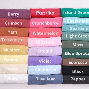 A collection of colorful t-shirts with various colors and patterns, including berry, paprika, island green, crunchberry, watermelon, light green, terracotta, pink, white, blue jean, black, and black pepper.