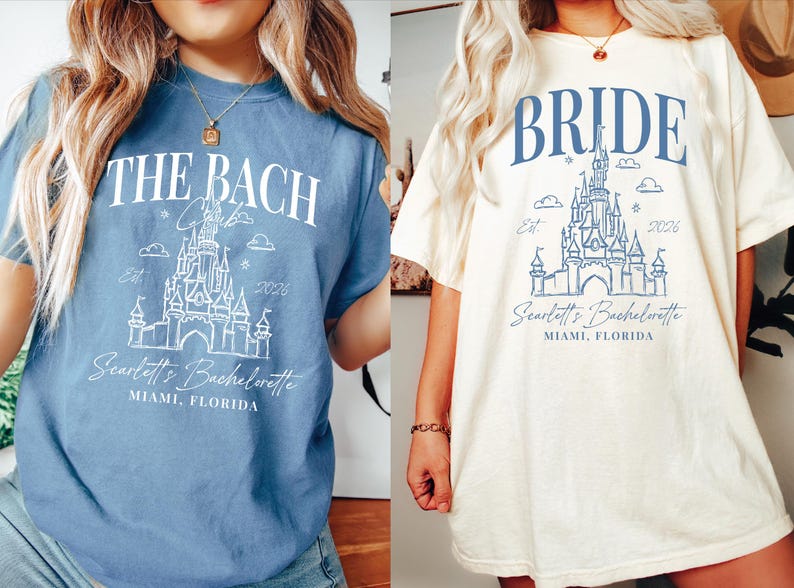 two women wearing t-shirts with a castle design and text related to a wedding or bachelorette party.