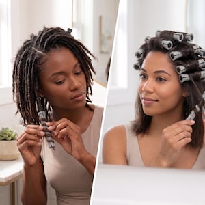 May include: Two women are shown in a bathroom setting, each styling their hair. One is using hair rollers on locs, while the other is using the same rollers on shorter, straight hair. The rollers are gray and white.