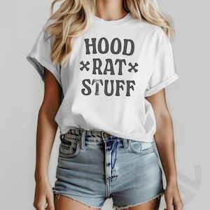 May include: White t-shirt with the text "HOOD *RAT* STUFF" printed in black.