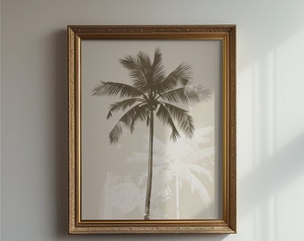 May include: A framed wall art piece featuring a dark silhouette of a single palm tree centred against a light beige background. The artwork is encased in an ornate, textured gold-toned frame with intricate detailing along the edges.