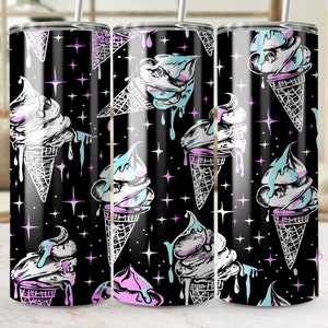 May include: A black and white tumbler with a repeating pattern of ice cream cones with pink and blue ice cream dripping down the sides. The background is black with white stars.
