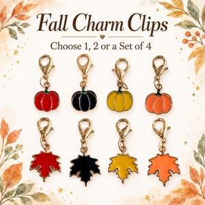 May include: A collection of eight metal charm clips featuring enamel pumpkin and maple leaf designs in red, black, yellow, and orange. The text Fall Charm Clips Choose 1, 2 or a Set of 4 is displayed above the charms, which have gold-toned clasps.