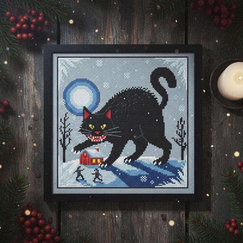 The Yule Cat cross stitch design embroidered on a light grey fabric, highlighting the snowy winter landscape and moonlight.