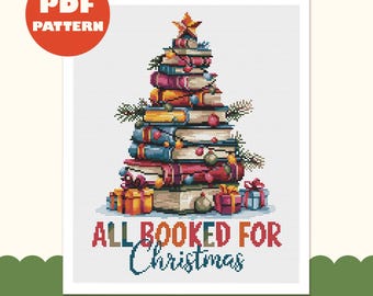 May include: A cross-stitch pattern featuring a Christmas tree constructed from a stack of colorful books, topped with a star, decorated with ornaments and pine branches, with gift boxes at the base and the text ALL BOOKED FOR Christmas.