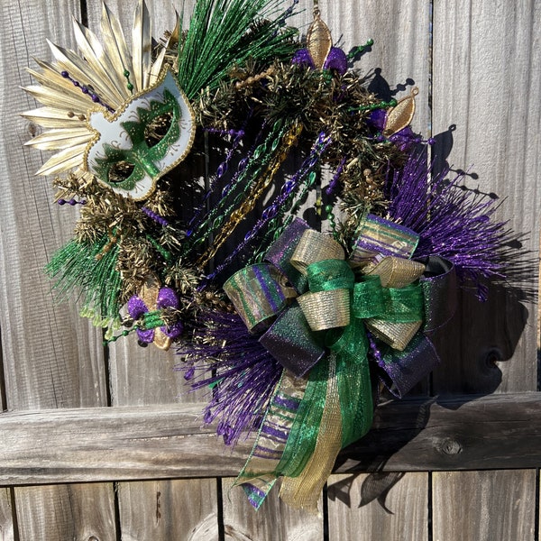 Mardi Gras gold wreath, green and white mask, purple, gold, green necklaces, decorative clips and ball sticks with gorgeous large bow.