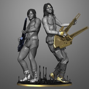 Puede incluir: Una escultura con dos figuras, cada una sosteniendo un instrumento estilizado. Las figuras están sin camisa y visten pantalones y botas. Un instrumento es negro y azul, el otro es dorado. La base es negra con detalles dorados.