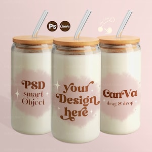 May include: Three glass tumblers with bamboo lids and clear straws. The tumblers are filled with a white liquid and have different designs on them. The first tumbler has the text "PSD smart object". The second tumbler has the text "your design here". The third tumbler has the text "Canva drag & drop".