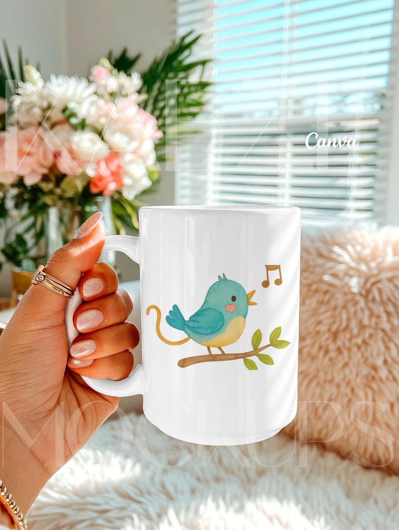 Hand held mug mockup created for Canva featuring a 15oz ceramic mug with a whimsical bird illustration design. Natural lifestyle composition with realistic grip, highlights, and ceramic texture. Mug body is editable via Canva drag and drop and also compatible with PSD smart object. Trendy mugs mockup for creative and playful 15oz mug mockup listings.