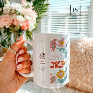 Trendy hand held mug mockup showing a 15oz ceramic mug with split view highlighting PSD smart object editing area. Realistic lighting, natural shadows, and true ceramic texture. Designed for easy artwork replacement using Photoshop smart objects. Professional mugs mockup perfect for premium 15oz mug mockup presentations and product previews.