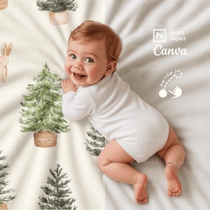 May include: A smiling baby wearing a white onesie lies on a cream-colored blanket decorated with watercolor illustrations of Christmas trees and a bunny. The blanket has the text "Canva" and "drag & drop".