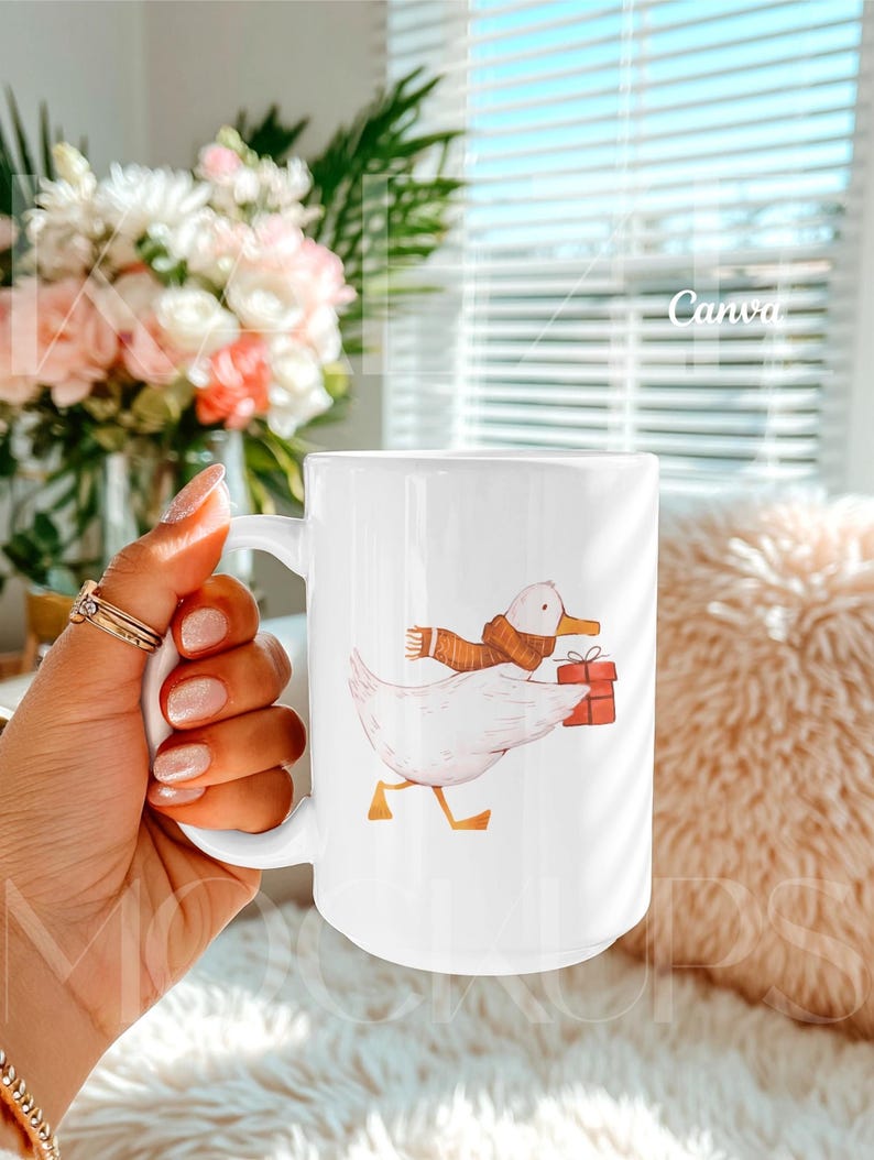 Hand held mug mockup optimized for Canva showing a 15oz ceramic mug with a playful illustrated duck artwork example. Clean lifestyle background with natural lighting and realistic hand positioning. Editable mug body allows easy design replacement via Canva drag and drop. Trendy mug mockups perfect for cute, illustrated, or gift-style 15oz mug mockup designs.
